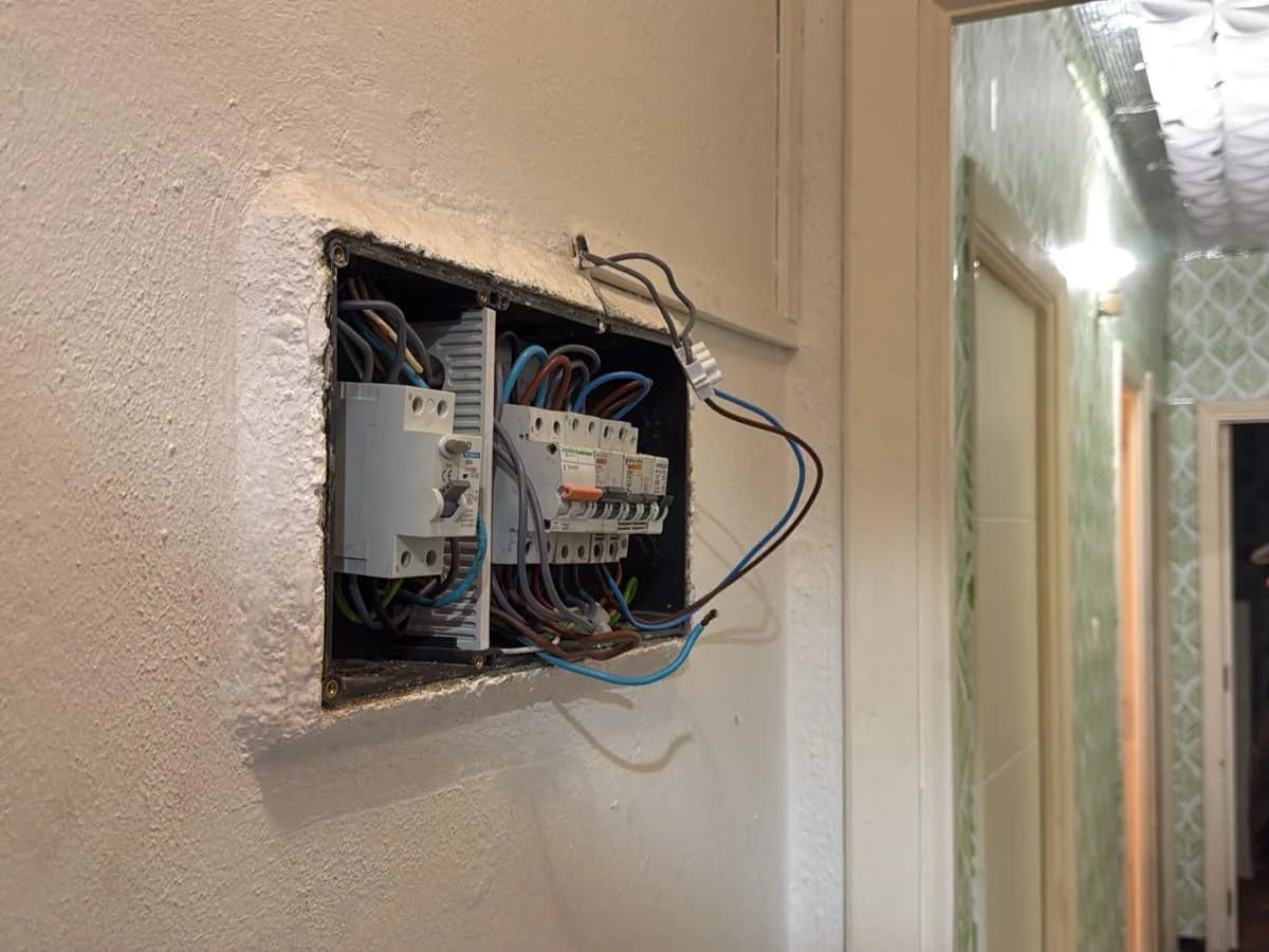Cuadro eléctrico empotrado abierto durante la instalación, con el cableado nuevo ya conectado